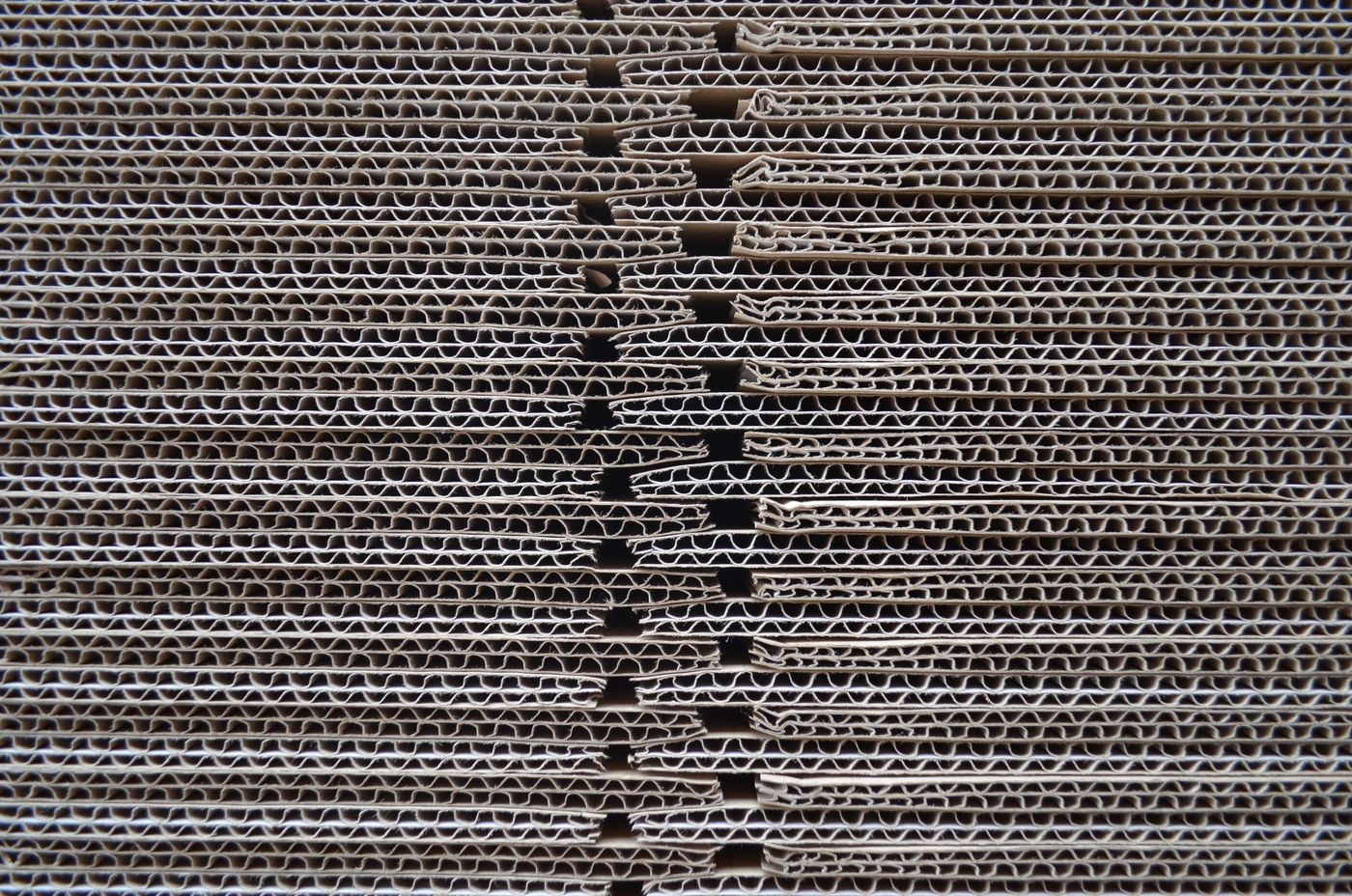 Stacked corrugated board sheets showing the fluted edge