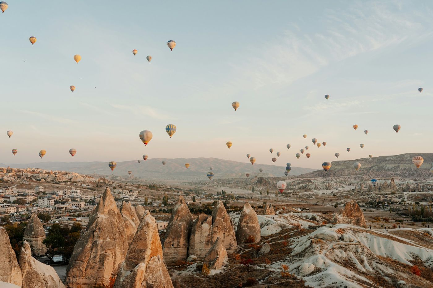 Hot-air balloons rising over the valleys of Cappadocia at dawn