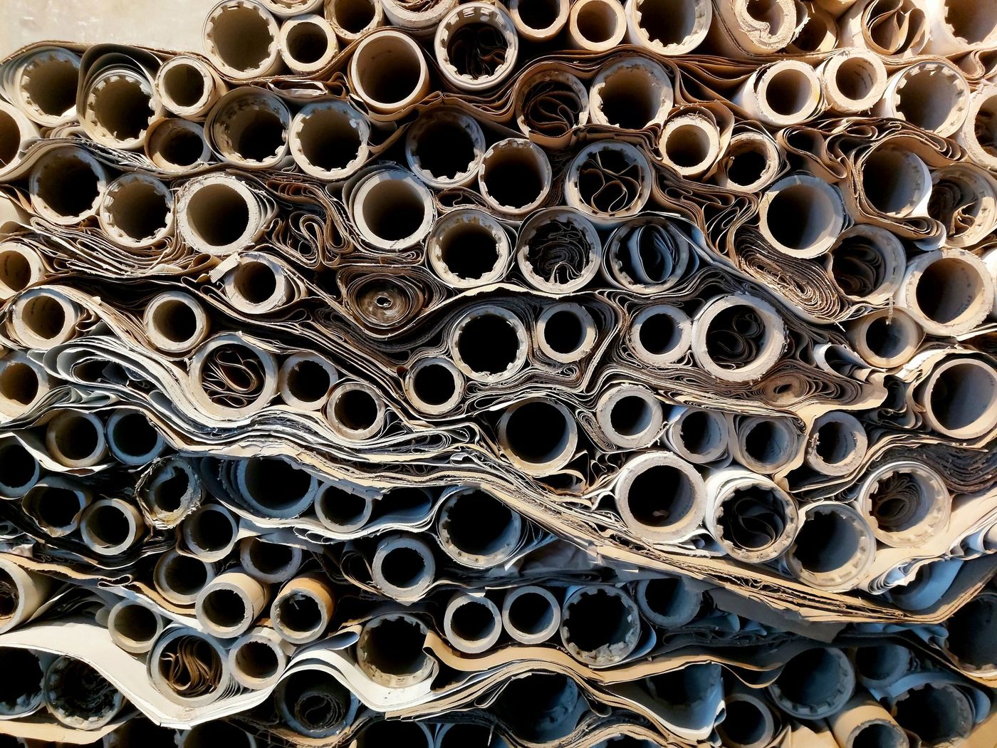 Close-up of stacked paper rolls seen end-on