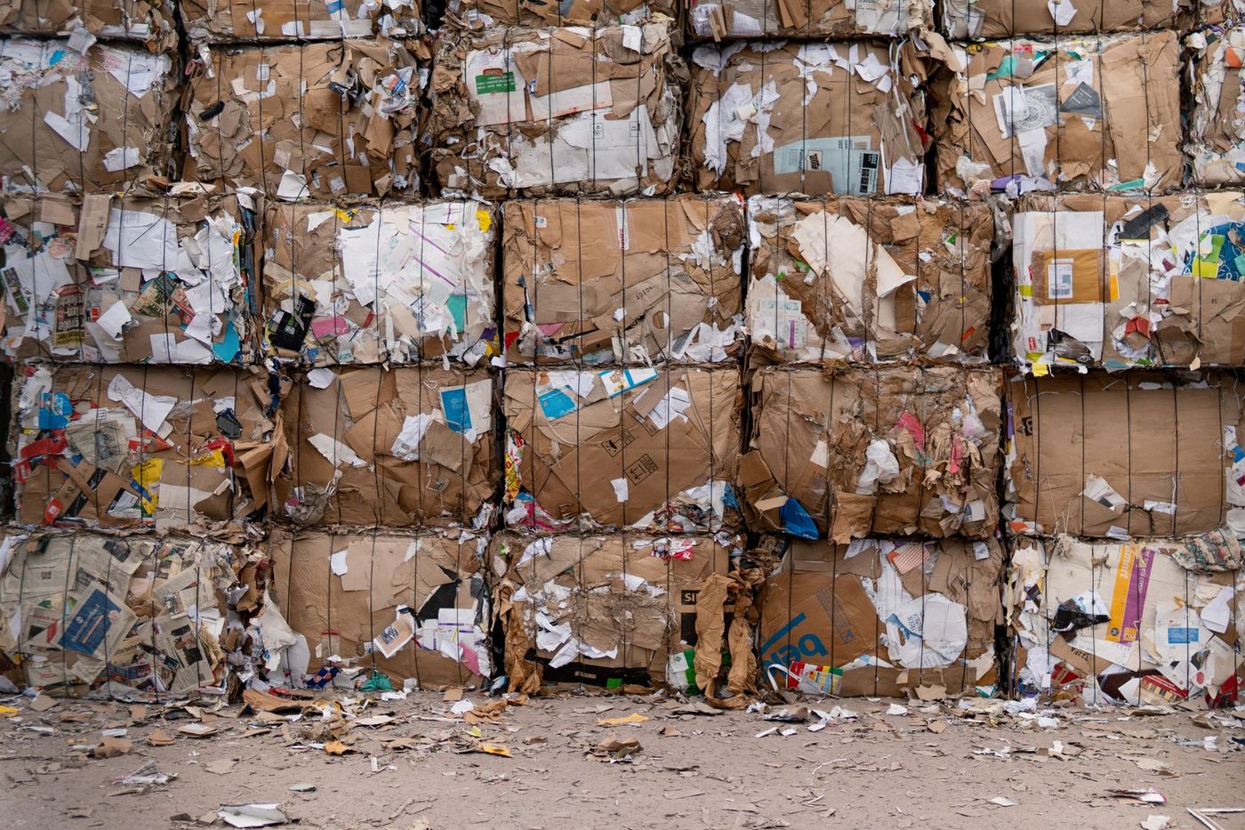 Bales of recovered corrugated cardboard stacked for processing